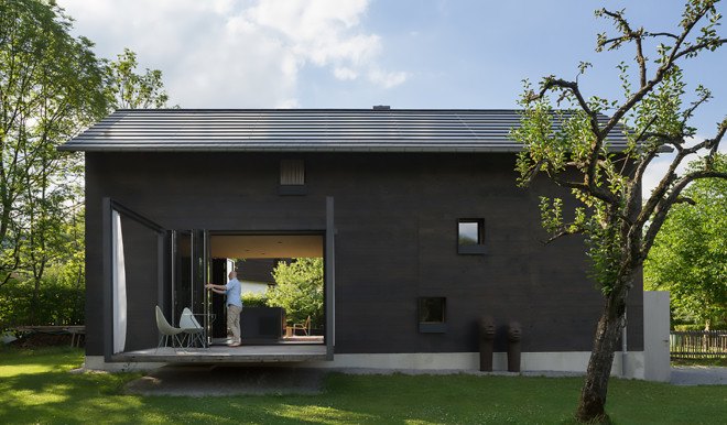 Holzhaus am Auerbach, Holzhaus am Auerbach by Christine Arnhard and Markus Eck, Christine Arnhard and Markus Eck, holiday home, alpine retreat, Urlaubs Architektur, Upper Bavaria, Germany, Upper Bavaria architecture, overhanging eaves, pitched roof, black stained timber, patina, split levels, Auerbach, cantilever,
