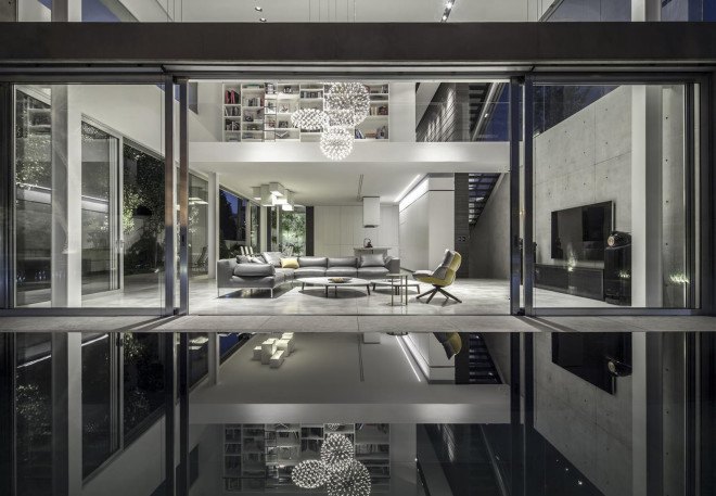Concrete Cut House, Tel-Aviv, Israel, Pitsou Kedem Architects, concrete, daylit spaces, glass facade, chandelier, swimming pool, family home