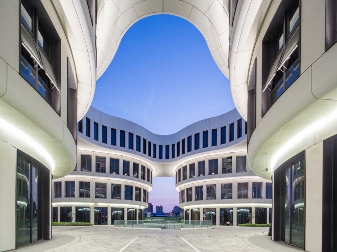 The top level of all four towers is merged together into the shape of a four-petaled flower with a cutout in the middle that allows light to pass through to the central courtyard.