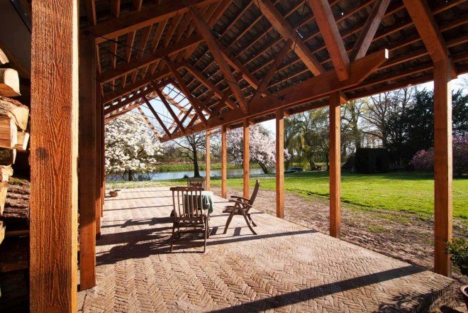 DeBossa, timber pavilion, indoor/outdoor space, split-level shelter, Dutch Mansion, The Netherlands, Eindhoven, Brabants Landschap, firewood storage, gable roof pavilion,
