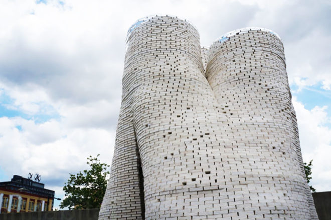curvy gray building made from mycelium