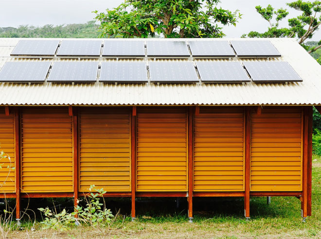 brown home with solar panels on roof