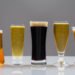 Five different shaped glasses with beer