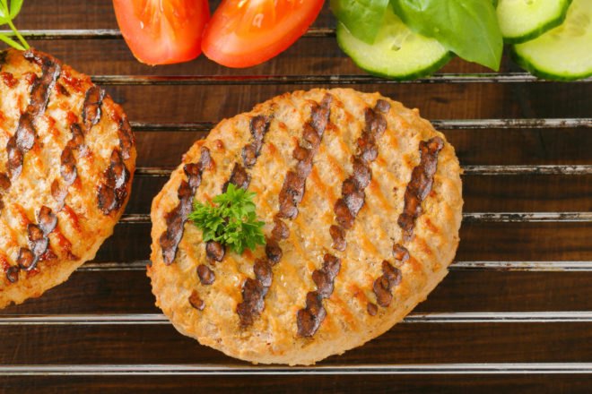 Two veggie patties on a grill