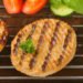 Two veggie patties on a grill