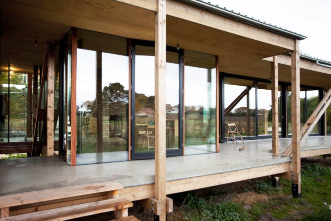 Peter Grundmann, prefab home, low cost home, House Neiling II, raised home, glass and wood minimal home, Berlin, single woman owner, DIY furniture, Löwenberger Land