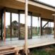Peter Grundmann, prefab home, low cost home, House Neiling II, raised home, glass and wood minimal home, Berlin, single woman owner, DIY furniture, Löwenberger Land