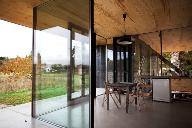 Peter Grundmann, prefab home, low cost home, House Neiling II, raised home, glass and wood minimal home, Berlin, single woman owner, DIY furniture, Löwenberger Land