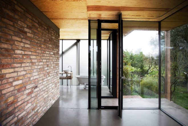 Peter Grundmann, prefab home, low cost home, House Neiling II, raised home, glass and wood minimal home, Berlin, single woman owner, DIY furniture, Löwenberger Land