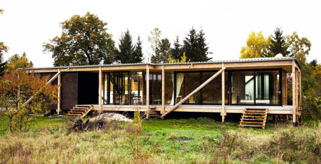 Peter Grundmann, prefab home, low cost home, House Neiling II, raised home, glass and wood minimal home, Berlin, single woman owner, DIY furniture, Löwenberger Land