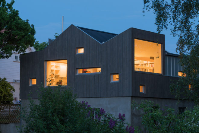 garage converted to library, garage conversions, Tjøme garage library conversion by NOMA Architects, tree-house like library, floor to ceiling bookshelves