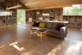 garage converted to library, garage conversions, Tjøme garage library conversion by NOMA Architects, tree-house like library, floor to ceiling bookshelves