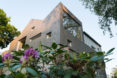 garage converted to library, garage conversions, Tjøme garage library conversion by NOMA Architects, tree-house like library, floor to ceiling bookshelves