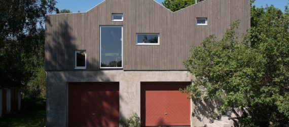garage converted to library, garage conversions, Tjøme garage library conversion by NOMA Architects, tree-house like library, floor to ceiling bookshelves