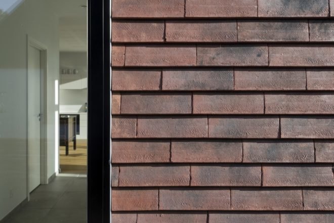 Villa Rypen by C.F. Moller, Aarhus modern home, Villa Rypen Aarhus, terra-cotta tilec screen facade, flexible interior layout for home, sliding doors interior design,