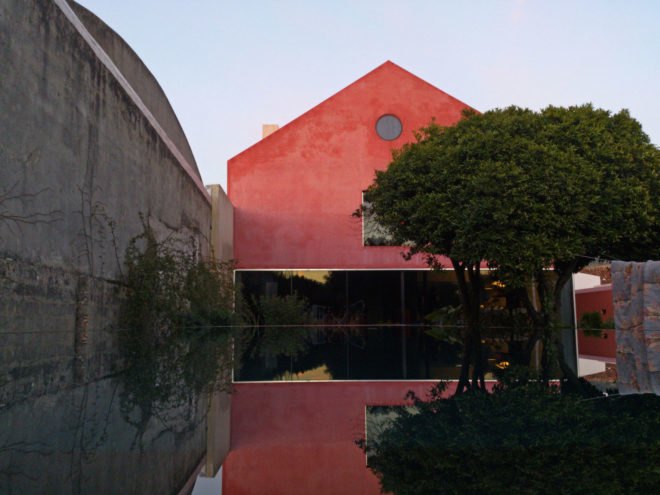 Red House by Extrastudio, Red House in Azeitao, winery transformed into home, adaptive reuse winery, Portugal adaptive reuse, contemporary architecture Portugal, minimalist and modern Portugal interior design, black glass sliding doors,