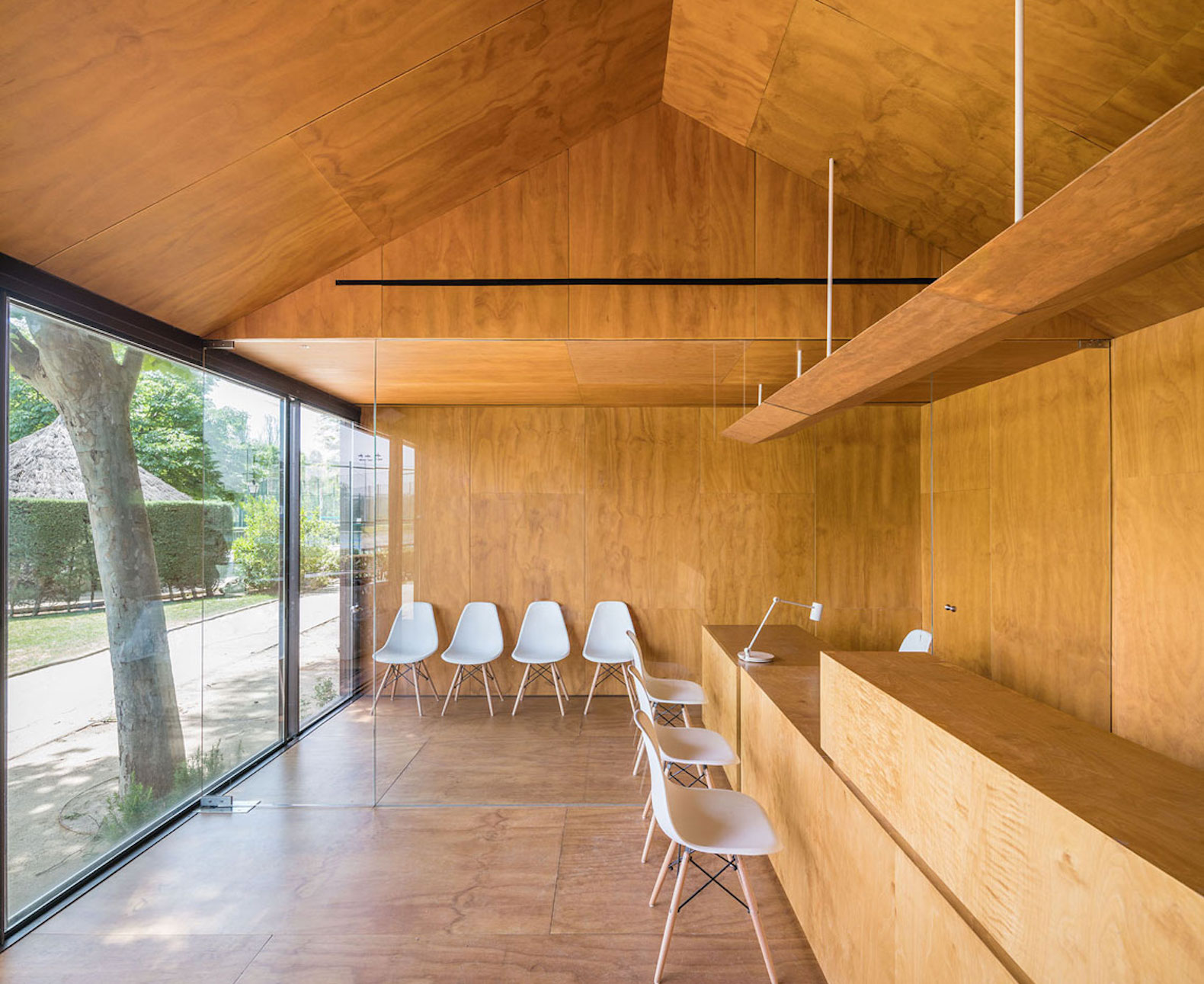 Tennis & Padel school office by BETA.o architecture office, BETA.ø architecture office, prefab office, prefabricated steel architecture, Madrid contemporary office architecture, pine plywood paneling, minimal site impact office design