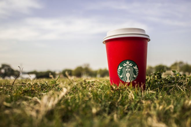 Starbucks, coffee, coffee cup, red coffee cup, red cup, grass, outside, nature