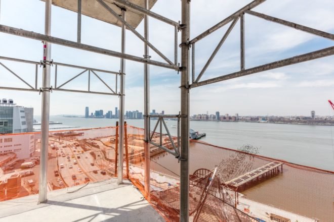 The Hudson River can be glimpsed from 40 Tenth Avenue, designed by Studio Gang, in New York City