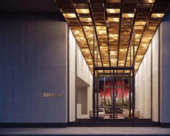 The hotel door enters into a garden featuring a Japanese maple tree.