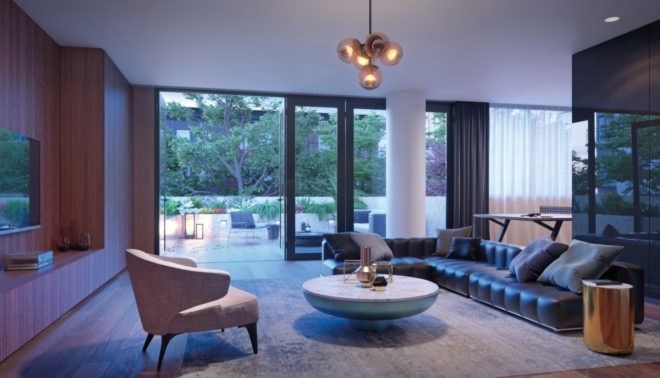 This living space features a bubble-like chandelier, an L-shaped dark leather couch, a sleek marble coffee table, and large glass windows and doors leading to an outdoor seating area.