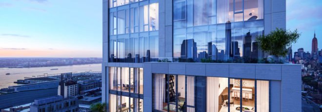 Image shows the exterior of 570 Broome at dusk. The building has tall floor-to-ceiling windows. and is surrounded by impressive views of New York City's buildings.