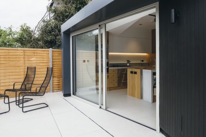 Large sliding glass doors connect open floor living space to the outside