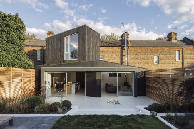 Charred timber extension attached to Victorian-era brick home