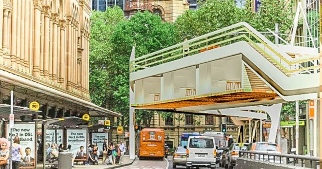 Cars and buses drive underneath housing units.