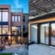 Exterior images of the home. On the left, an image of the entire building. On the right, image of sliding glass doors underneath the solar canopy.