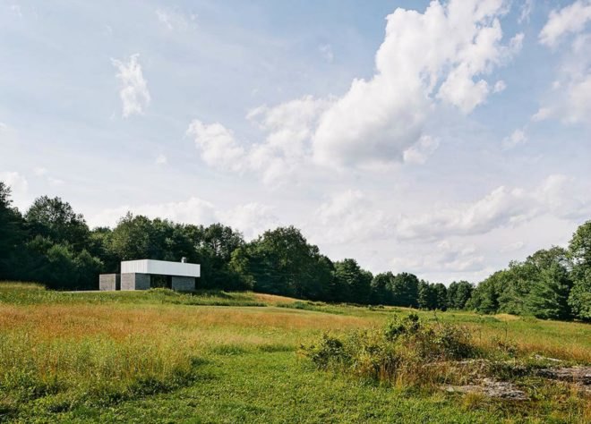 The concrete cabin sits on a vast amount of green land.