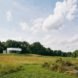 The concrete cabin sits on a vast amount of green land.