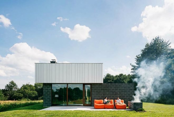 The family sits outside in bright orange lounge chairs.