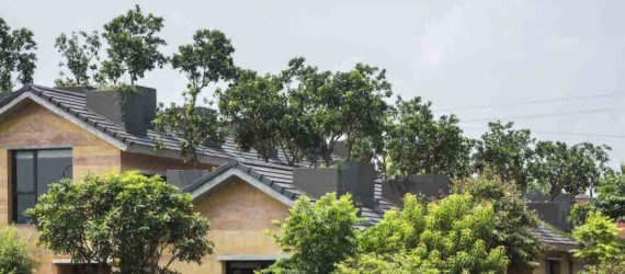 Dong Anh House by Vo Trong Nghia Architects, Dong Anh House in Hanoi, Dong Anh House in Vietnam, rammed earth modern architecture, rammed earth architecture in Hanoi, rammed earth housing in Vietnam, contemporary rammed earth house, fruit trees on a roof,