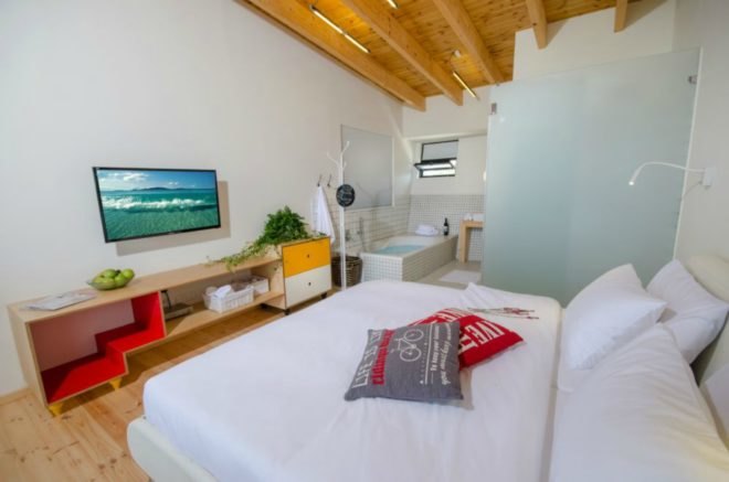 In the studio layout, the bed area extended further into an area that includes a hot tub.