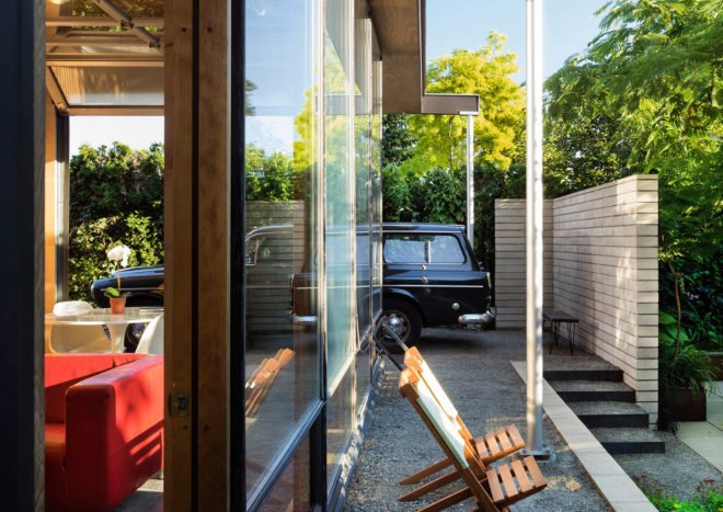 Two patio chairs sit just outside the studio's walls.