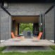 terrace features bright orange patio chairs
