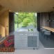 interior features kitchen island, long wood dining table and bright colored rug