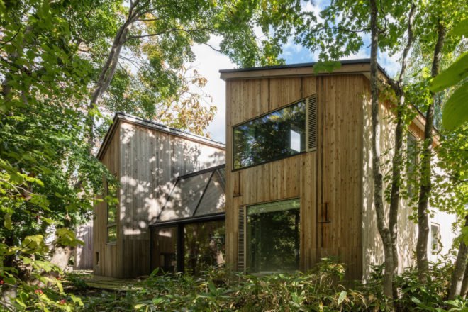 A rear view of a house made up of wooden cabins.
