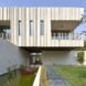Along one exterior wall of the home is a reflective pond.
