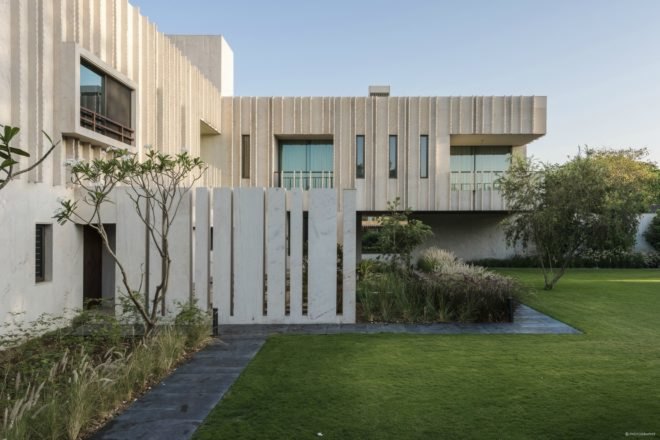 The stone exterior is surrounded by green courtyards.
