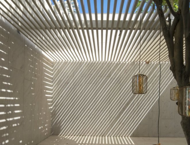 Sunlight filters through the slatted skylights.