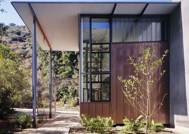 The roof extends past the outer walls to form covered terraces