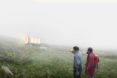 Hikers walk past the net zero shelter