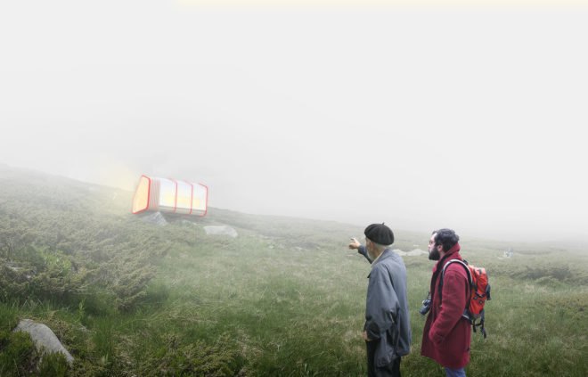 Hikers walk past the net zero shelter
