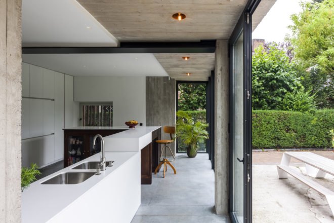 MILU by Qatarchitecten, green roof concrete extension, MILU house in Ghent, Ghent renovation and extension, board formed concrete extension, board formed concrete structural walls, operable glass garden backyard doors,