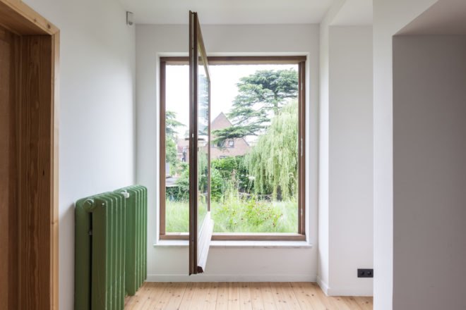 MILU by Qatarchitecten, green roof concrete extension, MILU house in Ghent, Ghent renovation and extension, board formed concrete extension, board formed concrete structural walls, operable glass garden backyard doors,