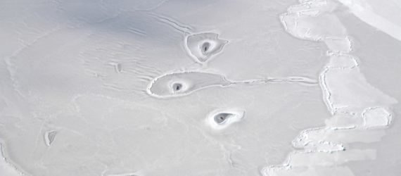 Mysterious holes in Arctic sea ice; image taken by Operation IceBridge's John Sonntag