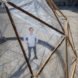 Michael PInsky posing inside Pollution Pods by Michael Pinsky