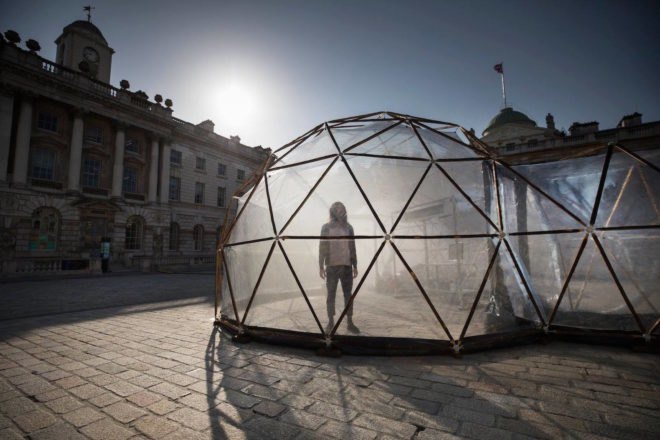 Visitor experiencing Pollution Pods by Michael Pinsky